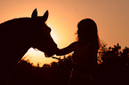 woman with horse in sundown