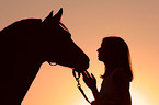 woman with horse in sundown