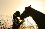 woman with horse at sundown