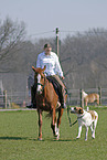 rider accompanied by dog