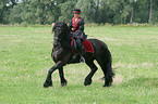woman with friesian horse at show