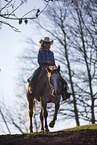 young girl rides on Appaloosa