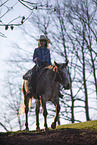 young girl rides on Appaloosa