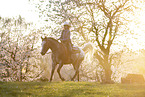 young girl rides on Appaloosa