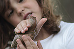 Child with African giant snail