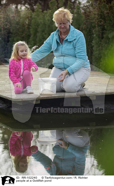 people at a Goldfish pond / RR-102240