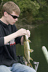 young angler with pike